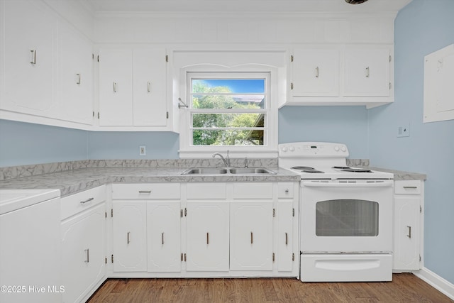 kitchen featuring electric range, wood finished floors, light countertops, white cabinetry, and a sink
