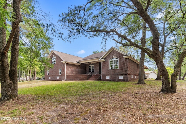 exterior space featuring brick siding, crawl space, covered porch, and a front yard