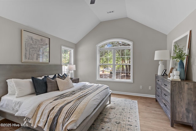 bedroom featuring visible vents, light wood-style floors, baseboards, a ceiling fan, and vaulted ceiling
