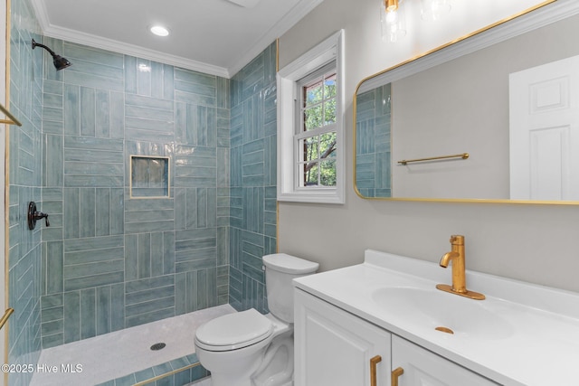 full bathroom with vanity, ornamental molding, toilet, and tiled shower