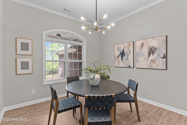 dining room featuring baseboards, an inviting chandelier, and ornamental molding