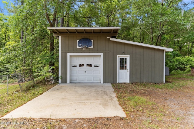 detached garage featuring fence
