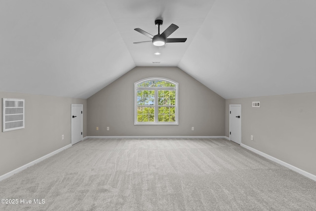 additional living space with carpet floors, ceiling fan, vaulted ceiling, and baseboards
