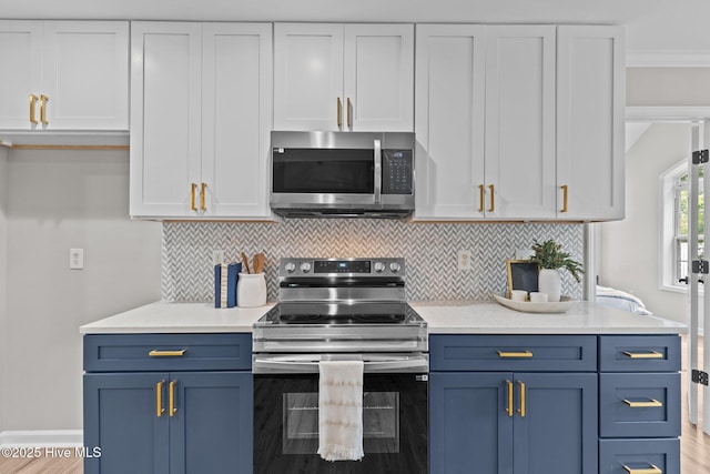 kitchen with light countertops, appliances with stainless steel finishes, blue cabinets, and white cabinets