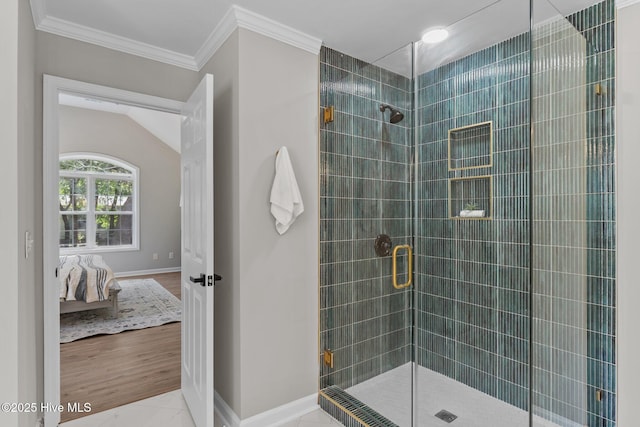 bathroom with connected bathroom, baseboards, ornamental molding, and a stall shower