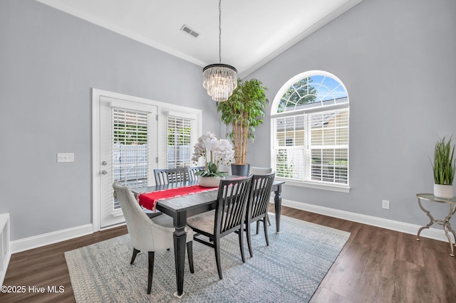 dining area with plenty of natural light, crown molding, visible vents, and an inviting chandelier