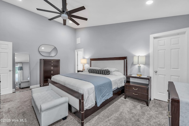 bedroom featuring recessed lighting, high vaulted ceiling, light carpet, and baseboards