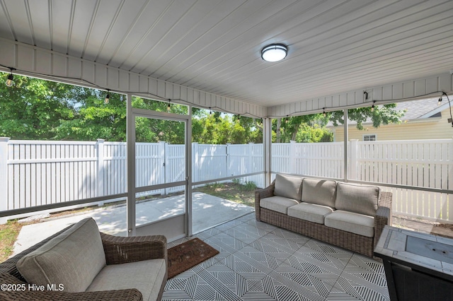 sunroom featuring an outdoor living space and a healthy amount of sunlight