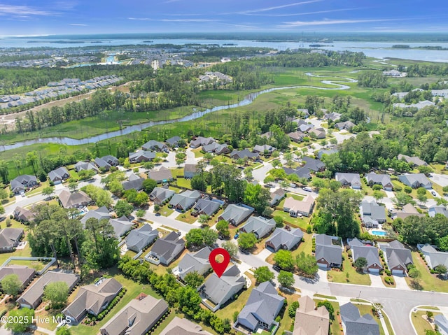birds eye view of property featuring a water view, a residential view, and golf course view