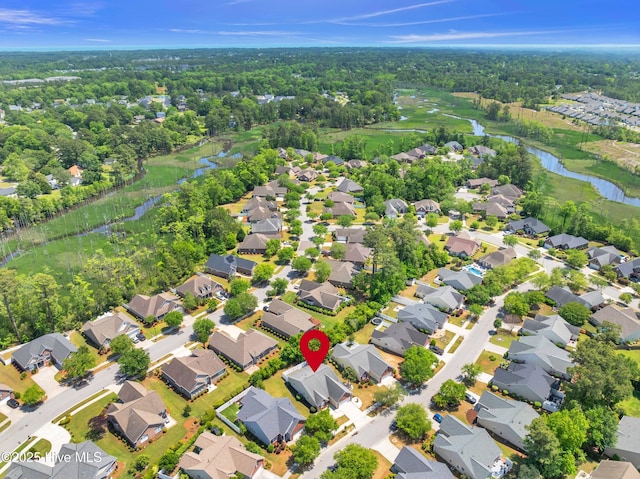 drone / aerial view with a water view and a residential view