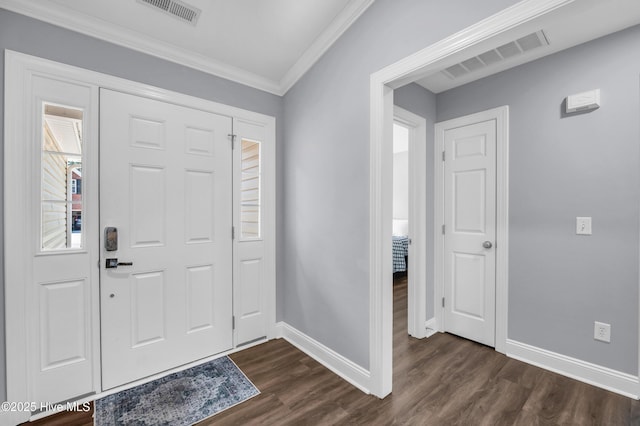entrance foyer featuring crown molding, dark wood-style flooring, baseboards, and visible vents