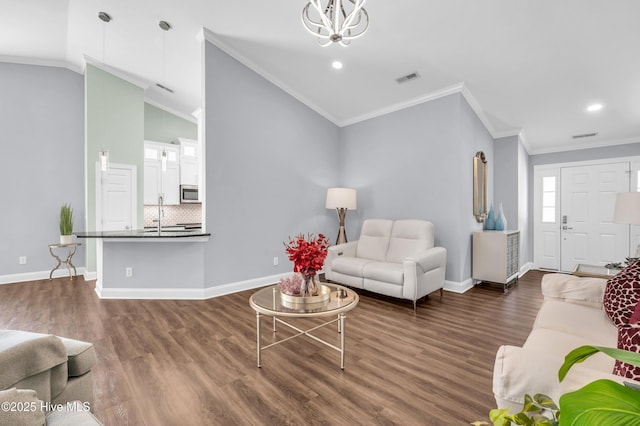 living area with visible vents, vaulted ceiling, dark wood finished floors, baseboards, and a notable chandelier