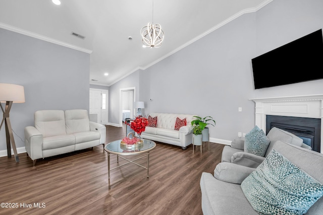 living area featuring visible vents, ornamental molding, lofted ceiling, baseboards, and a notable chandelier