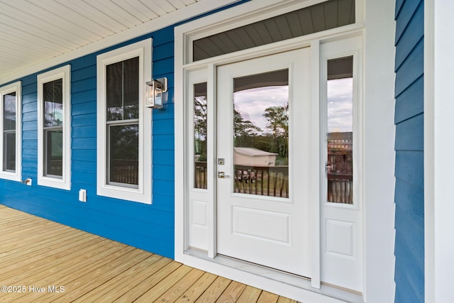 226 NE 64th St, Oak Island, NC 28465 - view of exterior entry with a porch