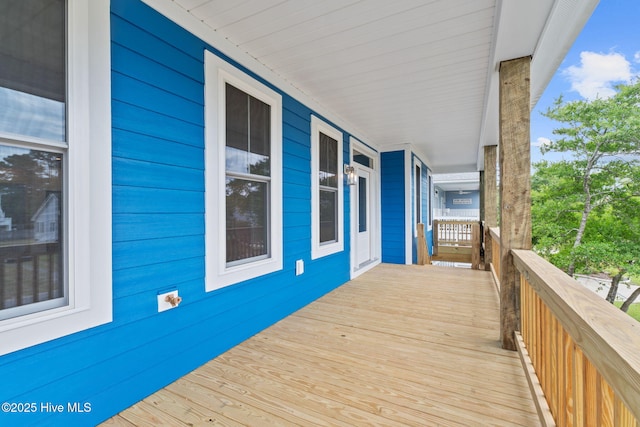 226 NE 64th St, Oak Island, NC 28465 - wooden terrace with a porch