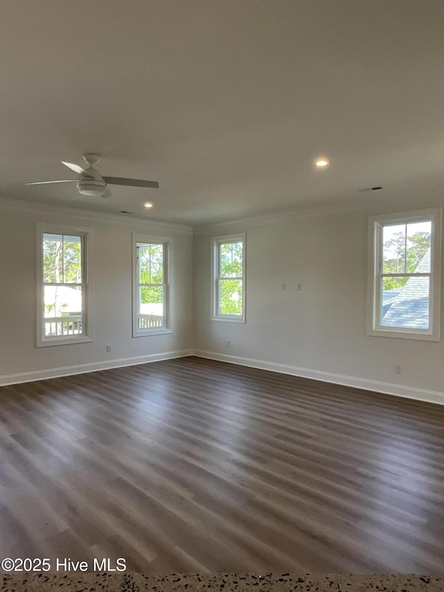 spare room featuring recessed lighting, baseboards, ornamental molding, and dark wood-style floors
