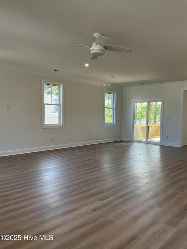 empty room with baseboards, ornamental molding, a ceiling fan, and a wealth of natural light