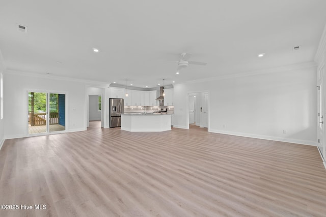 226 NE 64th St, Oak Island, NC 28465 - unfurnished living room with ornamental molding, a ceiling fan, baseboards, recessed lighting, and light wood-style flooring