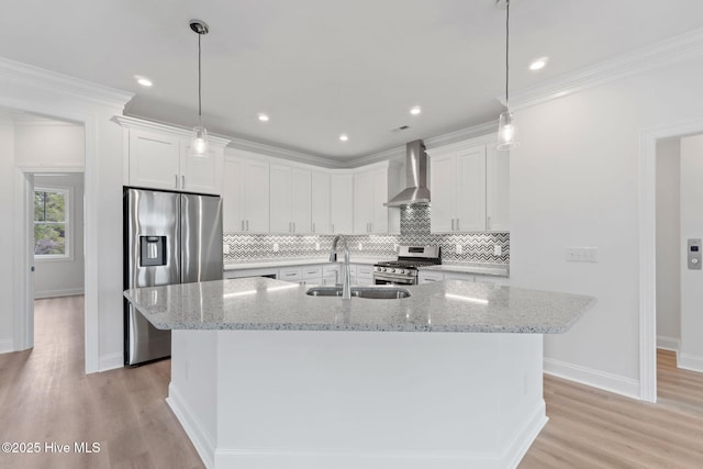 226 NE 64th St, Oak Island, NC 28465 - kitchen with stainless steel appliances, a sink, wall chimney exhaust hood, light wood-style flooring, and crown molding