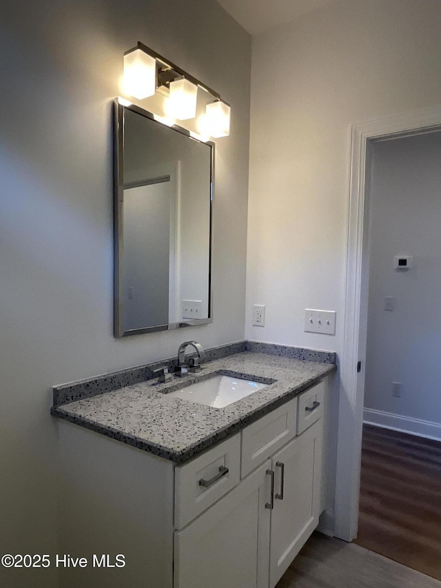 bathroom featuring wood finished floors and vanity