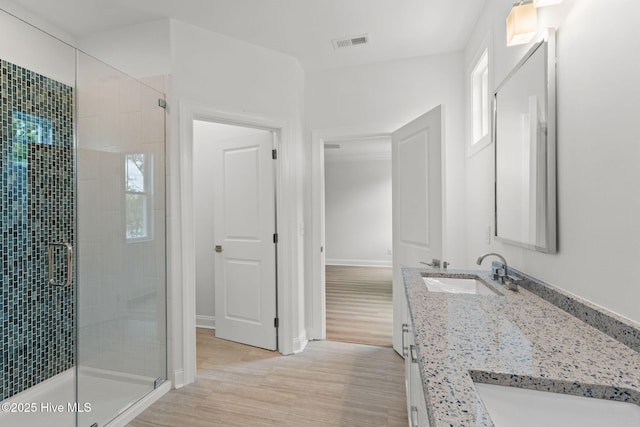 226 NE 64th St, Oak Island, NC 28465 - full bath with a stall shower, wood finished floors, double vanity, and baseboards