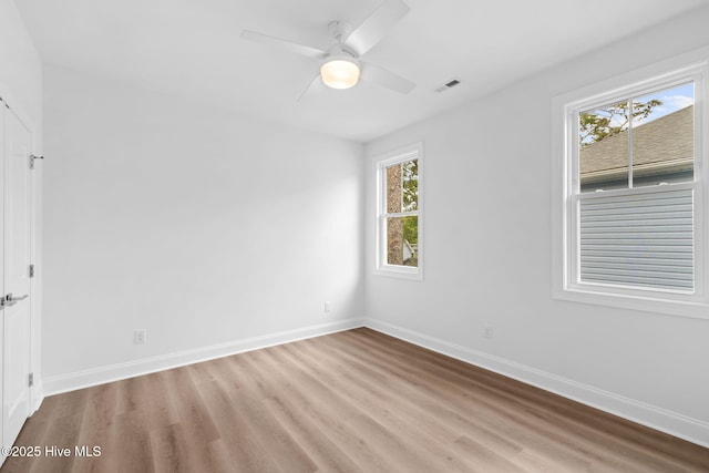 226 NE 64th St, Oak Island, NC 28465 - empty room with light wood-style floors, baseboards, and ceiling fan