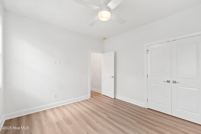 226 NE 64th St, Oak Island, NC 28465 - unfurnished bedroom with light wood-type flooring, a closet, baseboards, and ceiling fan