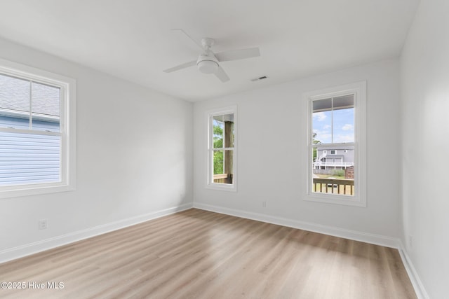 226 NE 64th St, Oak Island, NC 28465 - unfurnished room featuring plenty of natural light, light wood-style flooring, baseboards, and a ceiling fan