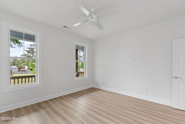 226 NE 64th St, Oak Island, NC 28465 - spare room featuring healthy amount of natural light, light wood-style flooring, baseboards, and a ceiling fan