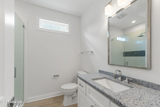 226 NE 64th St, Oak Island, NC 28465 - bathroom with a stall shower, wood finished floors, toilet, and vanity