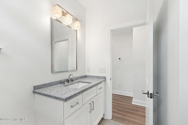 226 NE 64th St, Oak Island, NC 28465 - bathroom featuring wood finished floors, vanity, and baseboards