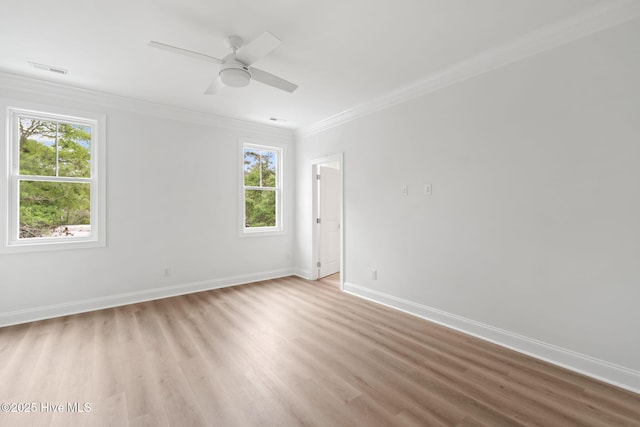 226 NE 64th St, Oak Island, NC 28465 - empty room featuring crown molding, healthy amount of natural light, light wood finished floors, baseboards, and a ceiling fan