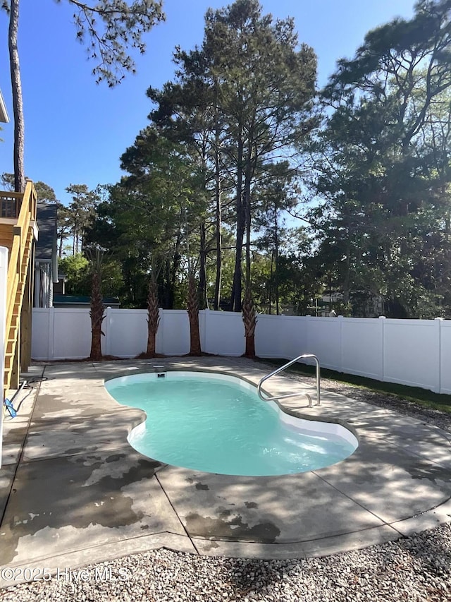 view of pool featuring a fenced in pool, a fenced backyard, and a patio area