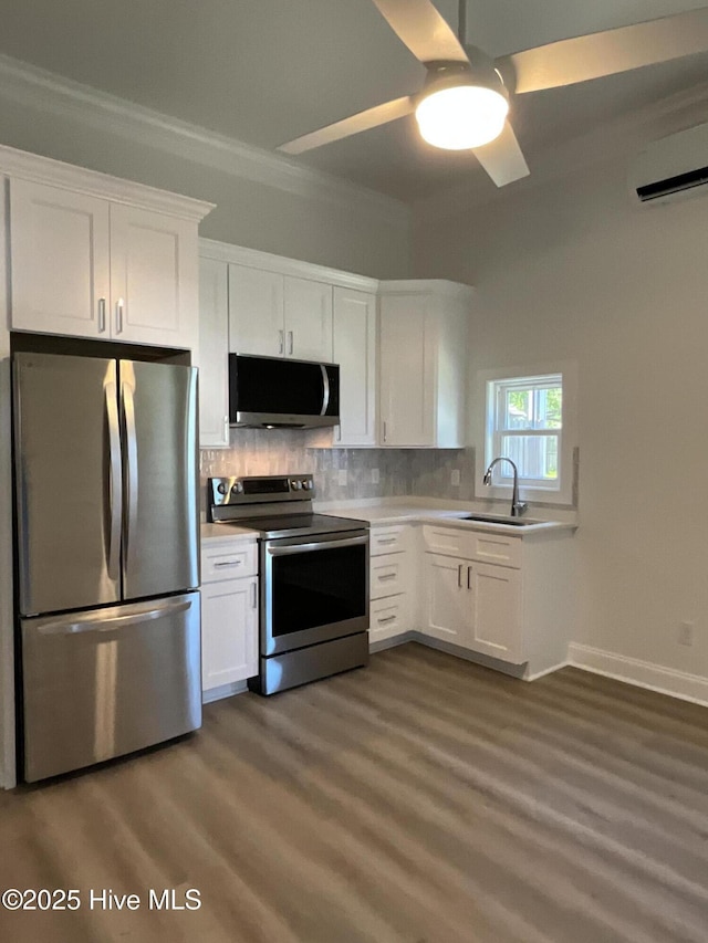 kitchen featuring light countertops, a sink, white cabinets, and stainless steel appliances
