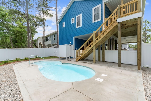 226 NE 64th St, Oak Island, NC 28465 - view of pool featuring stairway, a fenced backyard, and a patio