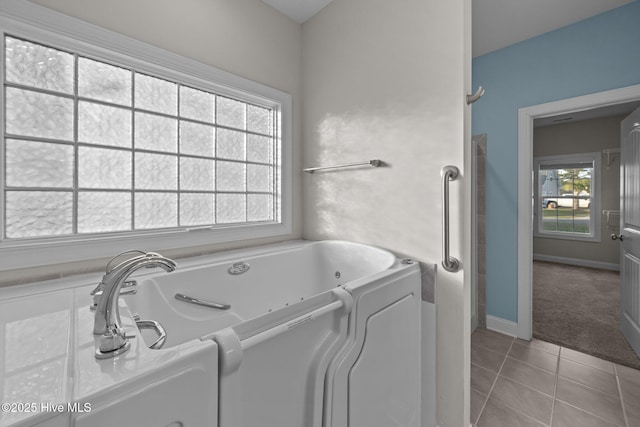 washroom with light tile patterned flooring, baseboards, and light carpet
