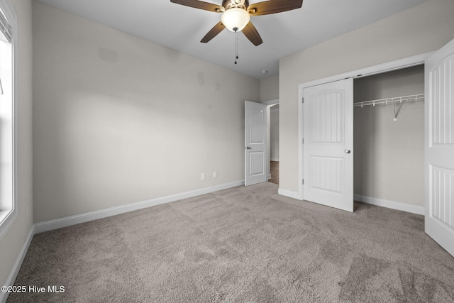 unfurnished bedroom with a closet, carpet flooring, baseboards, and ceiling fan