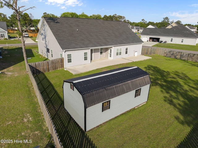rear view of property with a yard, a patio, and a fenced backyard
