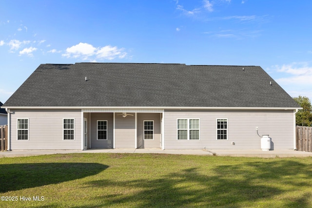 rear view of property with a patio, a lawn, and fence