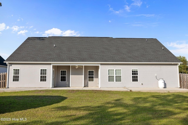 rear view of house with a lawn, fence, a ceiling fan, and a patio area