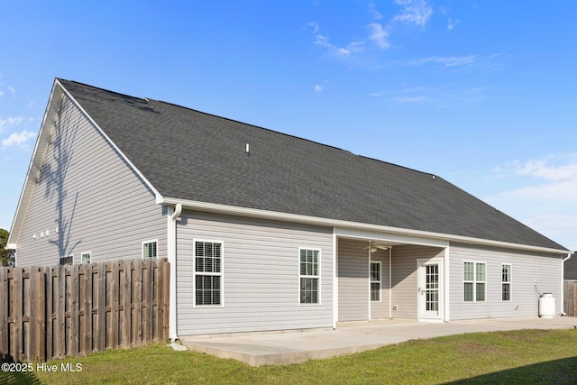 rear view of house with fence, a ceiling fan, and a patio area