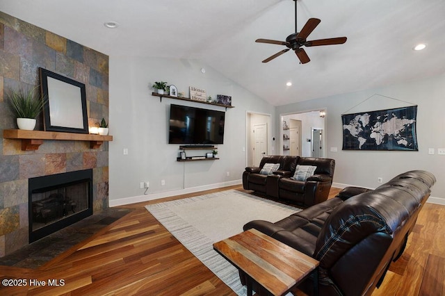 living room with ceiling fan, baseboards, lofted ceiling, and wood finished floors