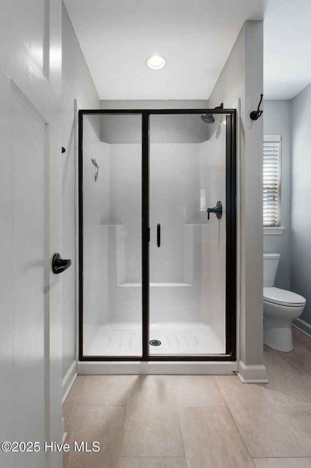 full bath with tile patterned flooring, toilet, recessed lighting, baseboards, and a shower stall