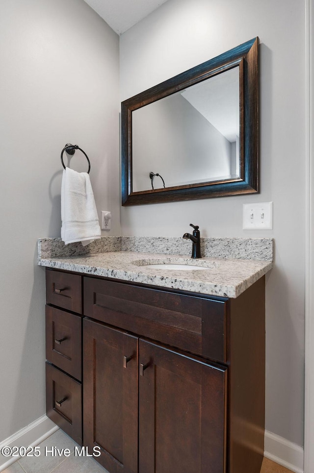 bathroom featuring baseboards and vanity