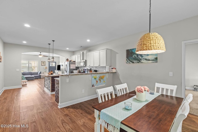 dining area with recessed lighting, ceiling fan, baseboards, and light wood-type flooring