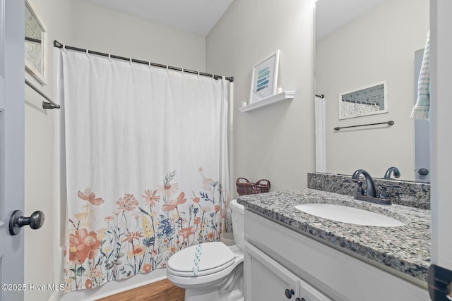bathroom featuring vanity, wood finished floors, shower / bath combination with curtain, and toilet