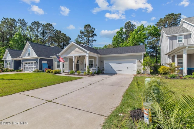view of front of property featuring an attached garage, board and batten siding, a front yard, covered porch, and driveway