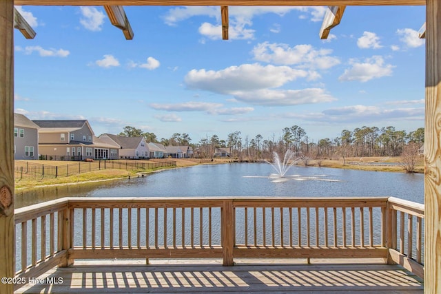 wooden deck featuring a residential view and a water view