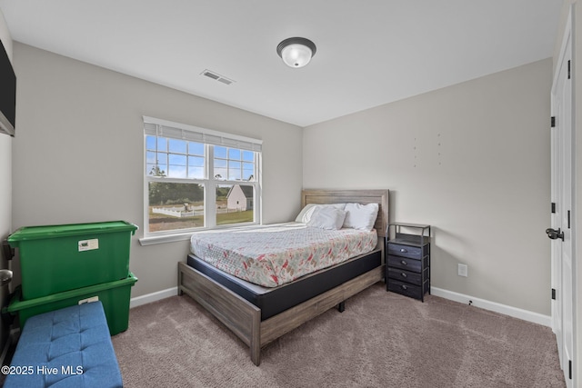 bedroom featuring visible vents, carpet, and baseboards