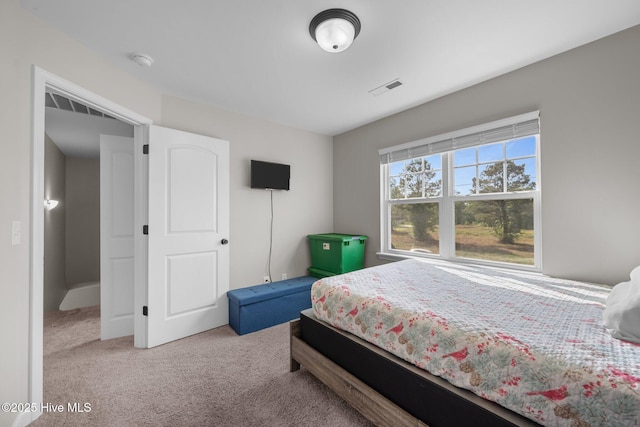 carpeted bedroom featuring visible vents